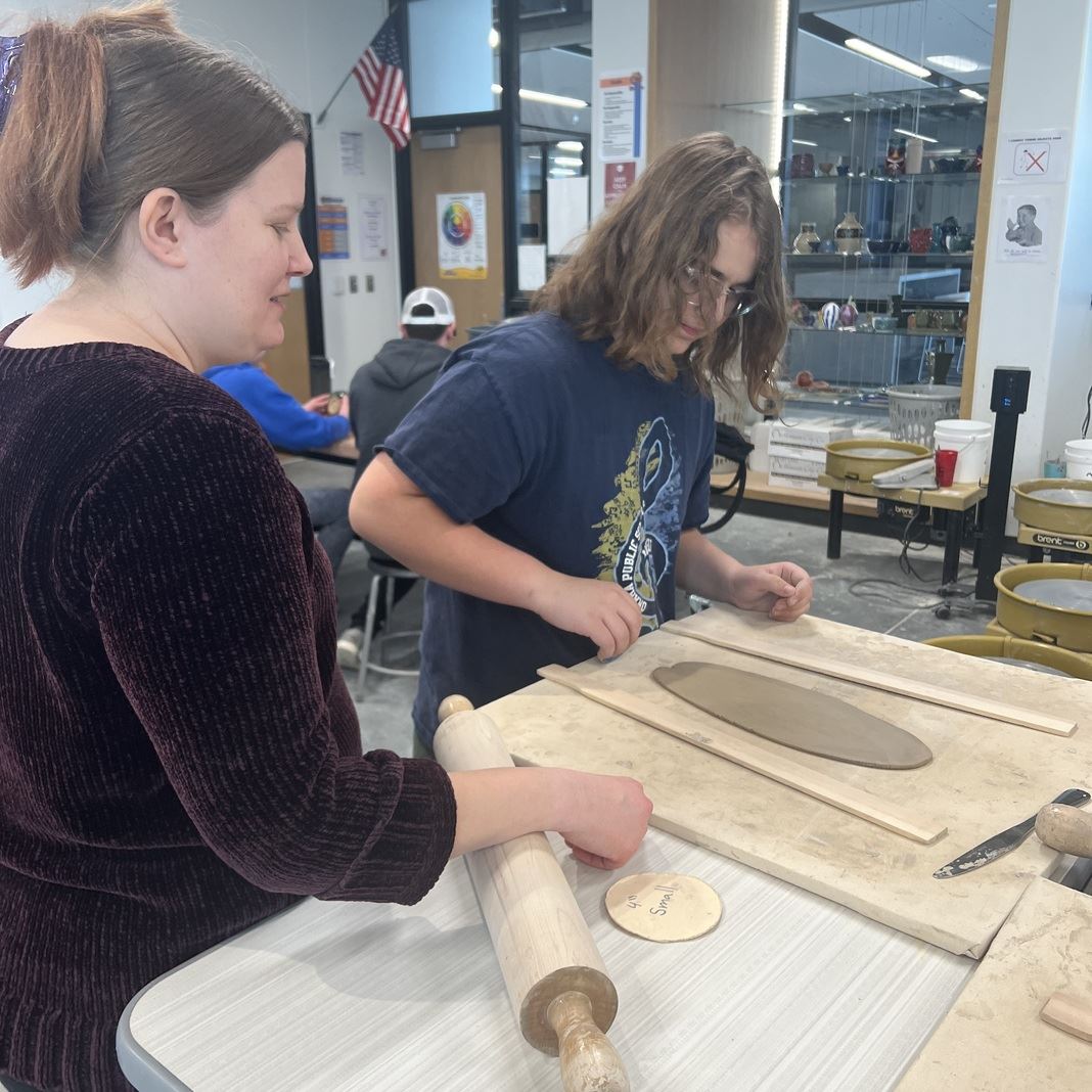  Students work with clay in art class